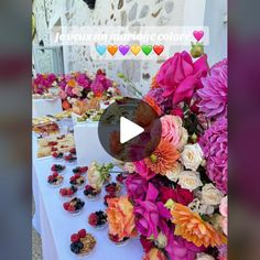 the table is full of colorful flowers and cupcakes on it's side