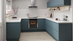 a kitchen with blue cabinets and white counter tops