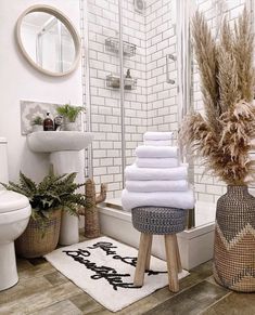 towels are stacked on stools in the bathroom