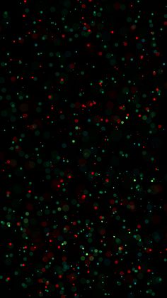 a black background with red and green dots