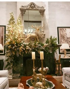 a living room filled with furniture and a fire place covered in christmas decorations next to a fireplace