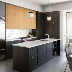 a modern kitchen with black cabinets and marble counter tops, along with an island in the middle