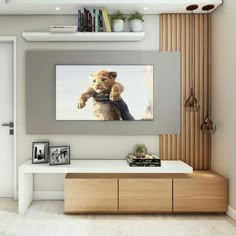 there is a television mounted on the wall with a lion cub holding something in it's hand