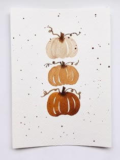 three pumpkins on top of each other in the shape of four different shapes and sizes