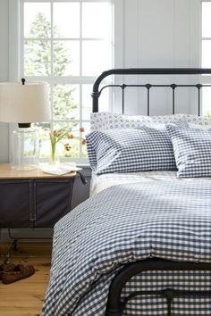 a bed with blue and white checkered sheets