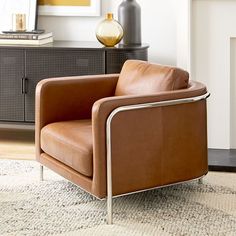 a brown leather chair sitting on top of a rug