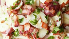 a plate with potatoes, bacon and parsley on it