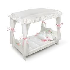 a white canopy bed with pink bows on the headboard and foot board, in front of a white background