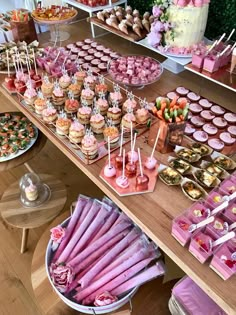 a table filled with lots of different types of desserts and candies on sticks