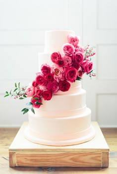 a white cake with pink flowers on top and the words, what do people you follow?