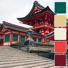 a red and white building with steps leading up to it's roof, in front of some stairs