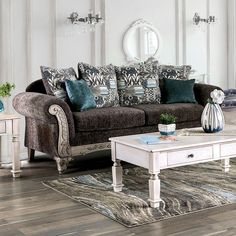 a living room filled with furniture and a white coffee table in front of a couch