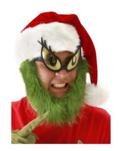 a man wearing a santa claus hat and green beard with glasses on his face, making a funny face