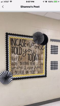 a school hallway decorated with black and white paper fan decorating the wall above it