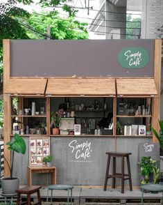 an outdoor cafe with wooden tables and stools