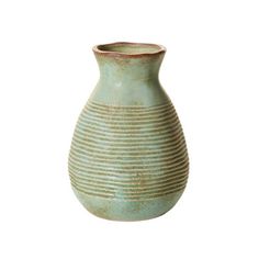 a green vase sitting on top of a white surface