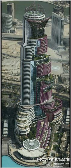 an aerial view of a tall building in the middle of a large body of water