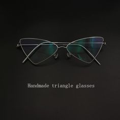 The Women's Handcrafted Stainless Steel Triangle Frame Eyeglasses are a stylish and customizable eyewear accessory that combines fashion and functionality. Made with premium stainless steel, these frames are designed to be durable and long-lasting, providing a comfortable fit for everyday wear. With a unisex design, these eyeglasses are suitable for both men and women, making them a versatile option for anyone looking to upgrade their eyewear collection. The unique triangle frame adds a modern a Angular Frames Glasses, Triangle Glasses, Geometric Glasses Frames, Luxury Silver Triangle Jewelry, Triangle Sunglasses, Handmade Triangle Sterling Silver Jewelry, Triangle Frame, Frame Eyeglasses, Beautiful Photoshoot