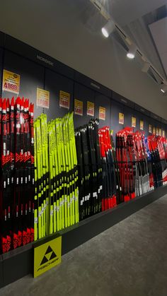 rows of skis are lined up on display in the store's snowboard section