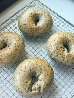 four bagels are sitting on a cooling rack