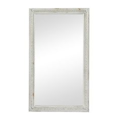 an ornate white framed mirror on a white wall with beading around the edges and bottom edge