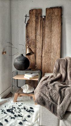 a living room with a couch, chair and wooden wall hanging on it's side