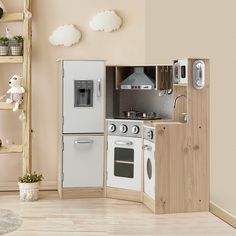 a toy kitchen with white appliances and wooden shelves on the wall, in a playroom