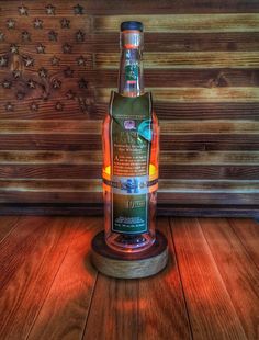 a bottle of whiskey sitting on top of a wooden table