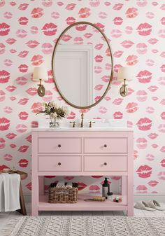 a bathroom vanity with pink and gold wallpaper