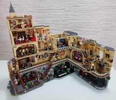 a lego model of a building with lots of people in it