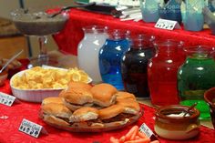 a table topped with lots of food next to jars and bowls filled with different types of foods