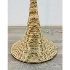 a large straw hat sitting on top of a wooden floor