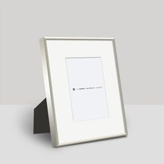 an empty white frame with a black stand