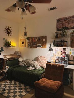 a bedroom with a bed, desk and ceiling fan in the corner next to a checkered rug