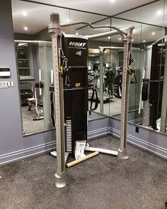 a gym with mirrors and equipment in it