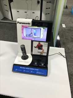 an electronic device is on display in a showroom for people to see and take pictures