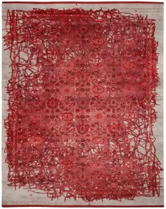 a red and white area rug with many circles on the top, in front of a gray background