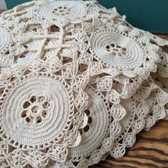 several crocheted doily on a wooden surface