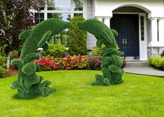 two lawn sculptures in front of a house