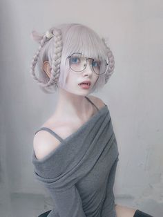 a mannequin wearing glasses and a gray dress with braids on it's head