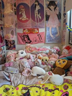 a bed with lots of stuffed animals on top of it and posters above the bedspread