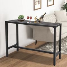 a living room with a couch, table and two wine glasses on the coffee table