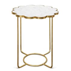 a white and gold side table with a flower design on the top, sitting in front of a white background