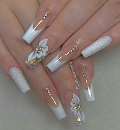 some white and gold nail designs with flowers on the tip of each one, while others are