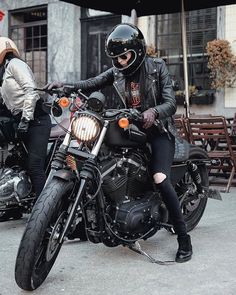 black and white photograph of two people on motorcycles