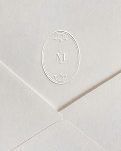 an open envelope with the letter m on it and a circle stamp that reads i love you