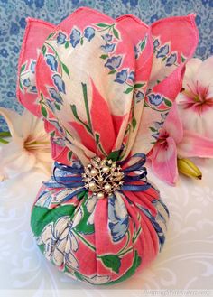 a pink and green flower sitting on top of a table