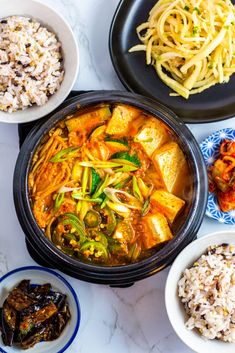 several different bowls of food on a table