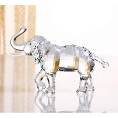 a glass elephant figurine sitting on top of a table