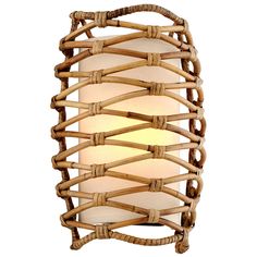 a light that is made out of wood and wicker with a white shade on it